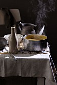 Steaming soup on a laid table