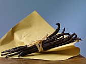 A bundle of vanilla pods on a piece of paper
