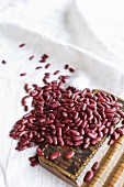 Organic kidney beans on a linen cloth and on a wooden board