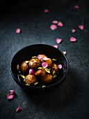 Gulab Jamun (Indian pastry balls) with pistachios and rose syrup