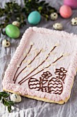 Mazurek (Polish Easter cake) with pink frosting and chocolate patterns