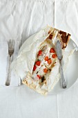 Fish with cherry tomatoes baking parchment paper