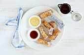 French toast sticks with maple syrup and white chocolate (seen from above)