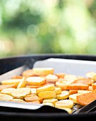 Sliced potatoes on a barbecue