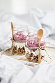 Muesli with yoghurt and raspberries in jars