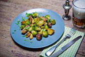 Fried potatoes with sausages and Brussels sprouts
