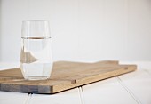 A glass of water on a chopping board
