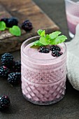 A blackberry smoothie garnished with mint