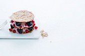 A layered cake made from wafer thin hazelnut biscuits and berry cream