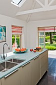 Island counter under exposed roof structure in modern kitchen