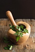 Fresh parsley in a wooden mortar