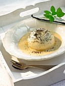 Dampfnudel (steamed, sweet yeast dumpling) with vanilla sauce and poppyseeds