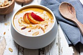 Pumpkin and carrot soup with caramelised apples and almonds