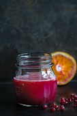 Pomegranate and blood orange juice in a jar
