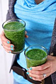 Glasses of spinach and cabbage smoothie with apple juice and chia seeds