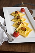 Branzini ravioli with mussels and braised tomatoes