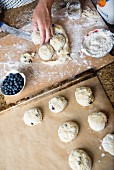 Blueberry scones being made: balls of dough being placed on a baking tray