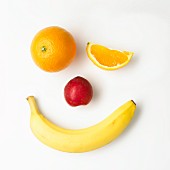 A fruit face on a white surface