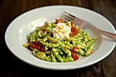 Fusilli pasta with pesto, dried tomatoes and ricotta cheese