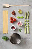 An arrangement of kitchen utensils and ingredients for pasta dishes