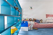 Blue partition shelving in cheerful, colourful child's bedroom