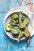 Spicy kale, pea and couscous fritters with an avocado, coconut and dill dipping sauce