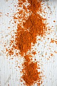 Chilli powder on a white wooden surface