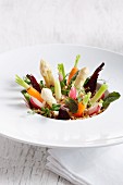 Various vegetables standing upright on a plate