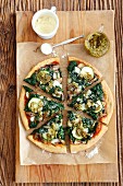 A vegetarian pizza topped with spinach, mushrooms and courgette