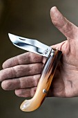 Someone holding a folding knife in an Italian knife factory