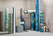 Rolls of wallpaper in various patterns and colours