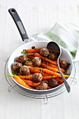 Moroccan meatballs with baby carrots in a pan