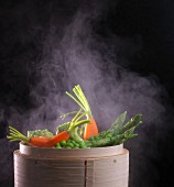 Vegetables being steamed in a bamboo basket