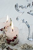 Candle lanterns made from ice with berries frozen in next to moose pastry cutter