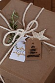 Gift wrapped in brown paper with whit cord and hand-made gift tags