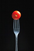A tomato on a fork