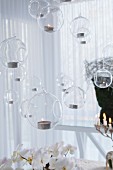 Tealights in suspended in glass baubles giving the effect of floating soap bubbles