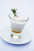 A rosemary cappuccino with a rabbit skewer