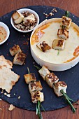 Oven-warmed cheese with white bread kebabs and nuts