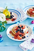 Pancakes with cream, strawberry sauce and berries for Easter