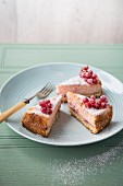 A three slices of sugared redcurrant cheesecake on a plate.