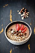 A smoothie bowl with grapfeuit, spelt flakes and hazelnuts
