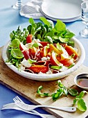 Peppered peach salad with rocket, proscuitto, mozzarella and basil