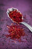 Saffron threads on a spoon and next to it