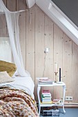 Romantic attic bedroom with board walls