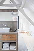 Attic bathroom with wooden floor and exposed roof beams