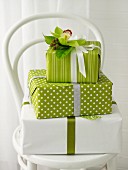 Stacked gifts in green and white with floral decoration