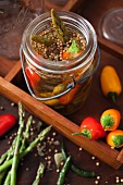 Asparagus and peppers with pickling spices in a vintage preserving jar