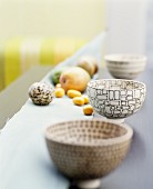 Three bowls with graphic patterns and fruit