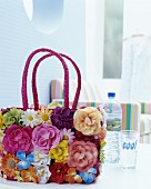 Basket bag decorated with artificial flowers